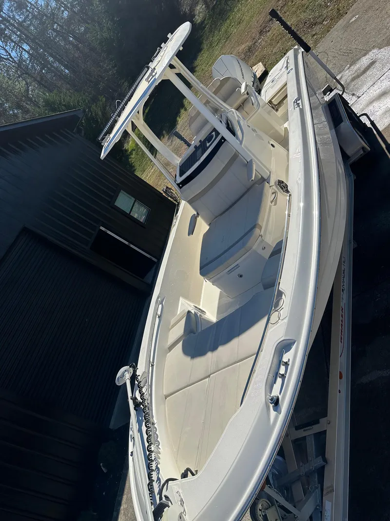 Slide: The Image of 2023 Boston Whaler 250 Dauntless boat on trailer, parked outdoors. - 9