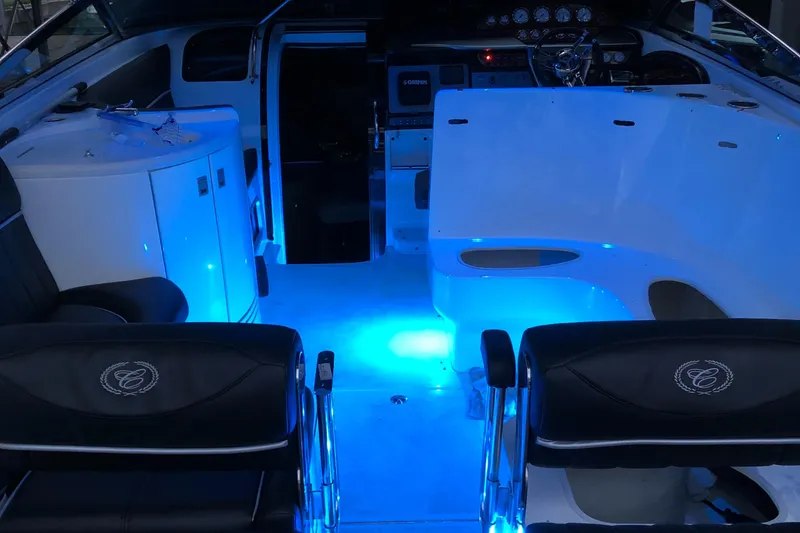 Slide: The Image of Interior of 2005 Cobalt 360 boat with blue ambient lighting and sleek seating. - 11