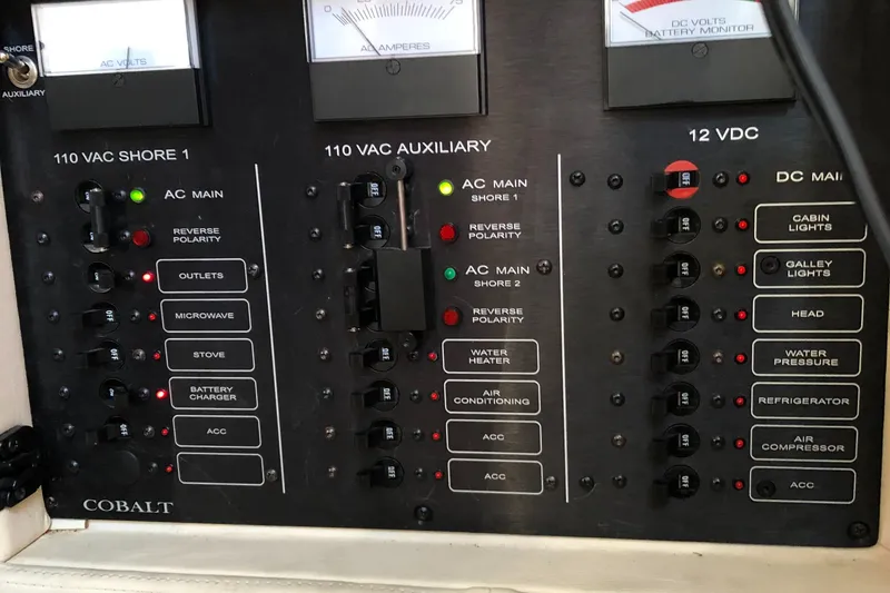 Slide: The Image of Electrical control panel of a 2005 Cobalt 360 boat, featuring various switches and indicators. - 12