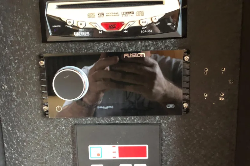 Slide: The Image of Audio system controls in a 2005 Cobalt 360 boat dashboard. - 15