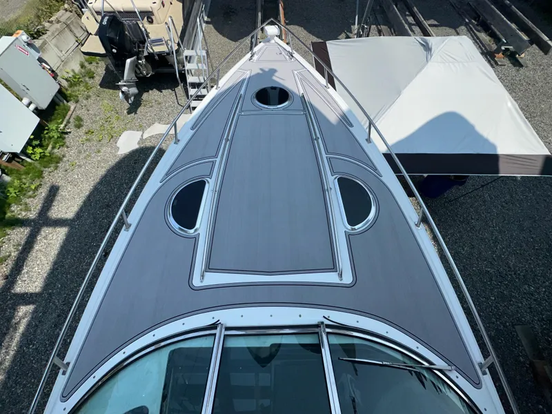 Slide: The Image of Top view of a 2005 Cobalt 360 boat docked, showcasing its sleek deck design. - 2