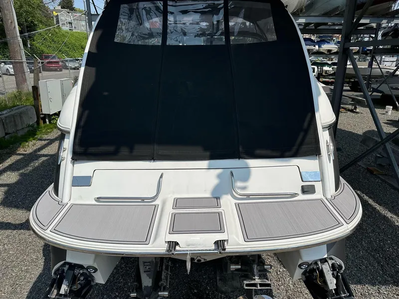 Slide: The Image of 2005 Cobalt 360 boat rear view with covered deck and dual engines. - 3