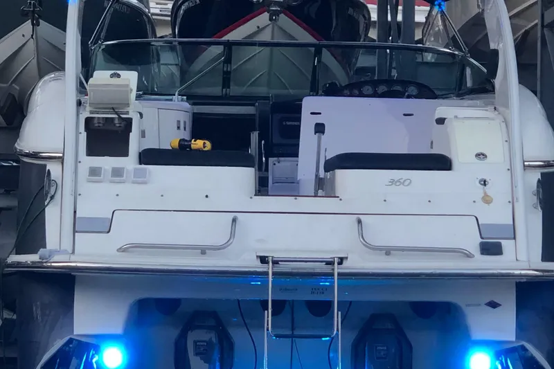 Slide: The Image of 2005 Cobalt 360 boat with illuminated blue lights, docked in a marina. - 7