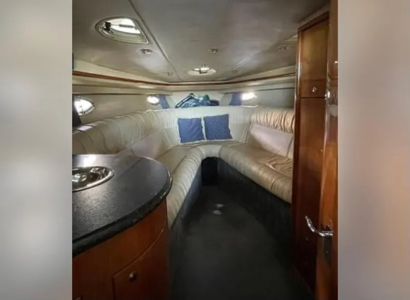 Slide: The Image of Interior of a 2005 Cobalt 360 boat with plush seating and wooden cabinetry. - 8