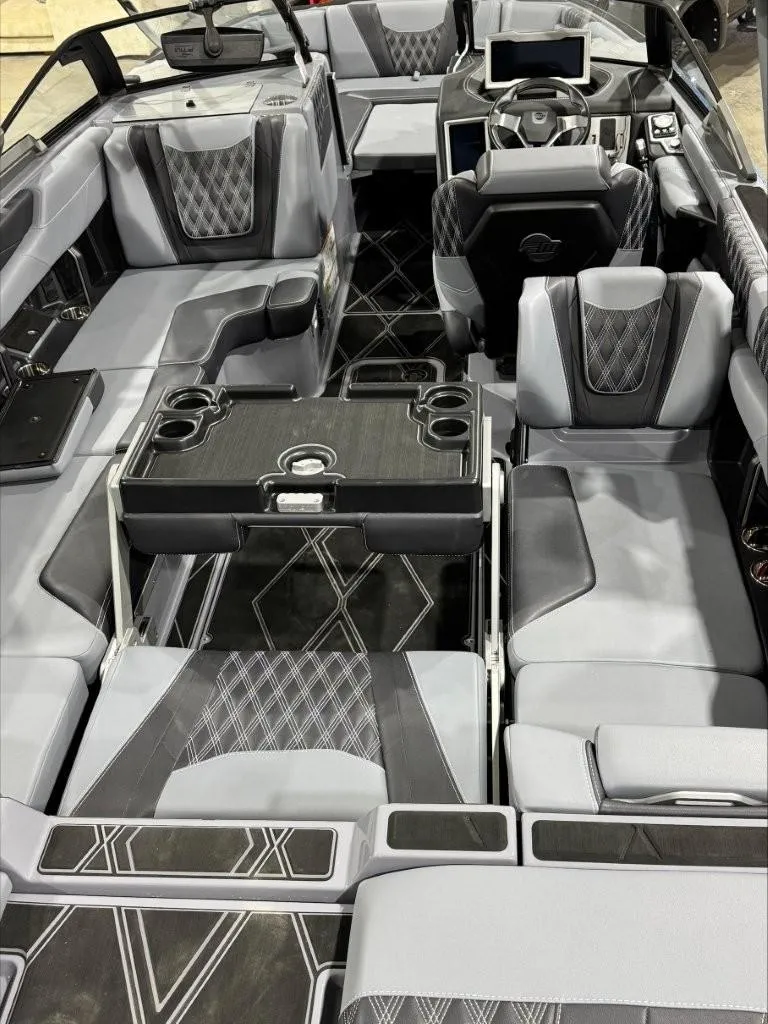 Slide: The Image of 2024 Malibu M242 boat interior with luxurious seating and modern dashboard design. - 10
