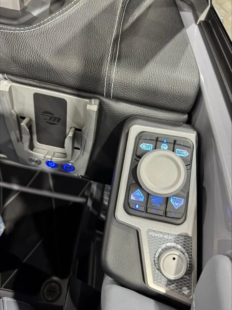 Slide: The Image of 2024 Malibu M242 boat control panel with power seat adjustment and sleek design. - 14