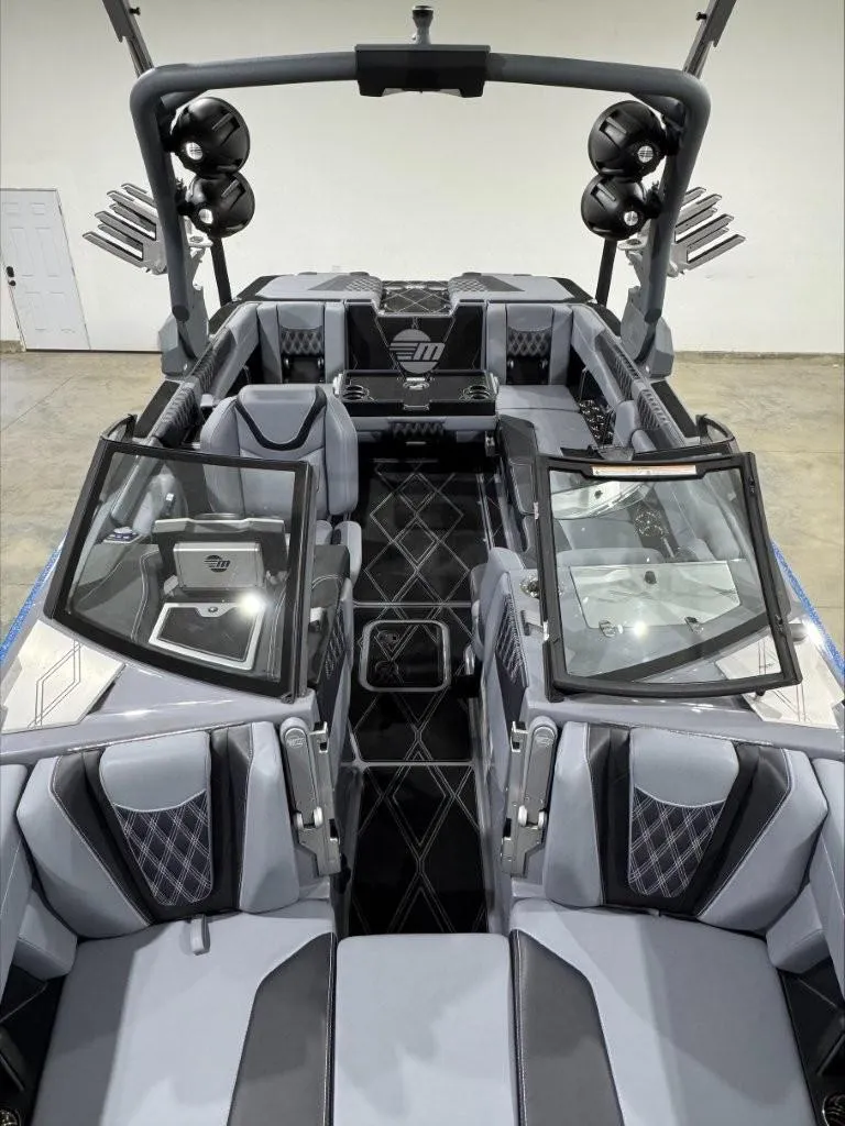 Slide: The Image of 2024 Malibu M242 boat interior with luxurious seating and advanced audio system. - 15
