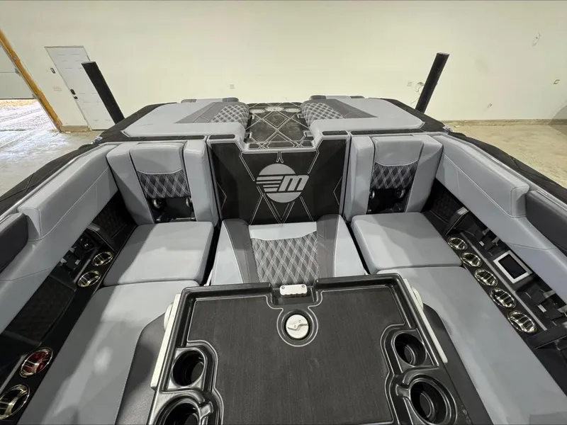 Slide: The Image of 2024 Malibu M242 boat interior with luxurious seating and modern design features. - 16