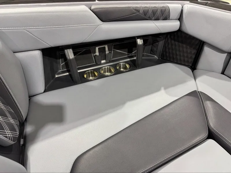 Slide: The Image of 2024 Malibu M242 interior seating with cup holders and stylish stitching. - 18