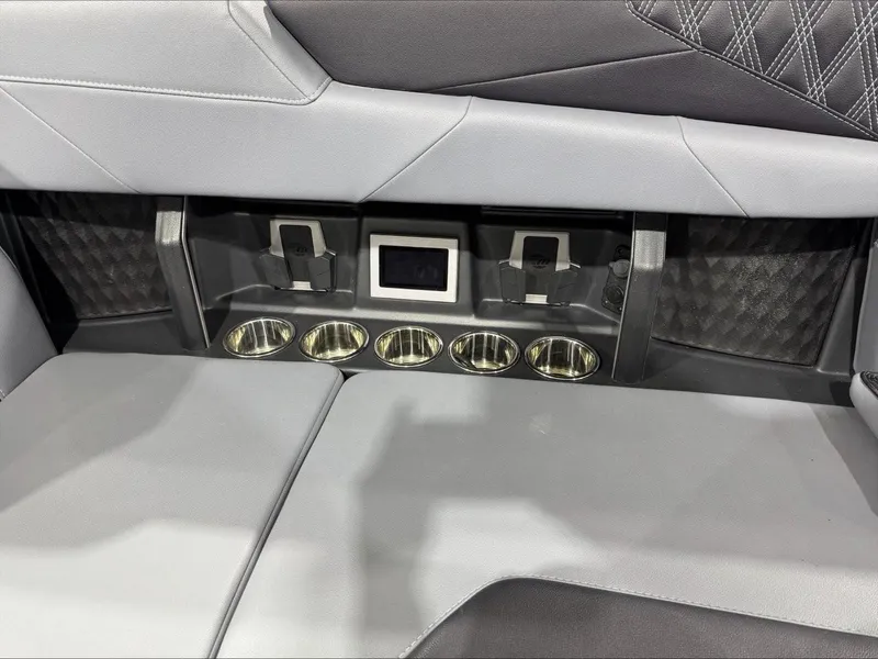 Slide: The Image of 2024 Malibu M242 interior with cup holders and sleek seating design. - 19