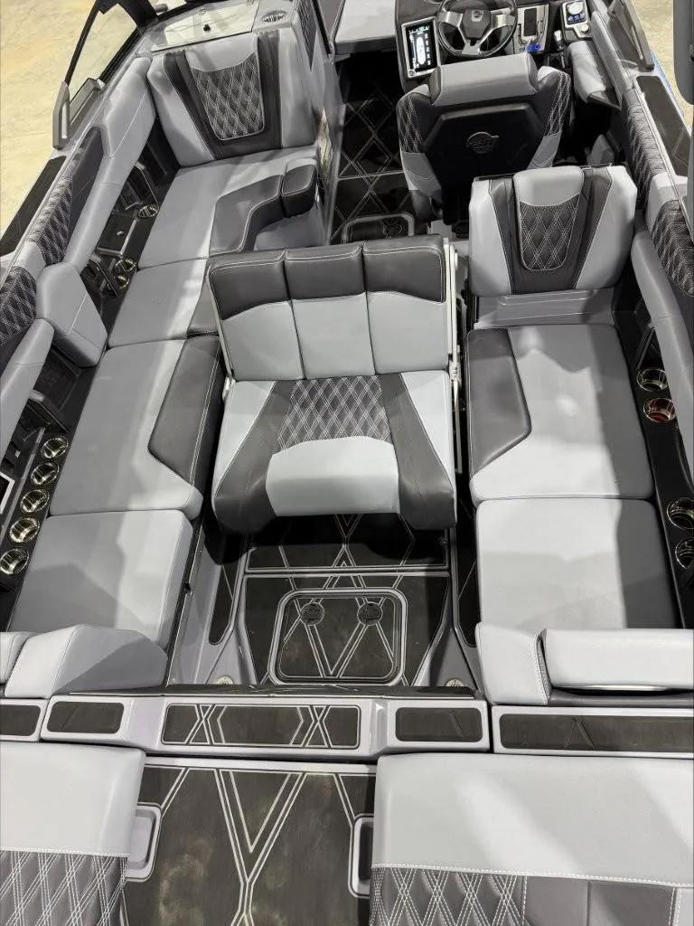 Slide: The Image of 2024 Malibu M242 boat interior with luxurious gray seating and modern design. - 9