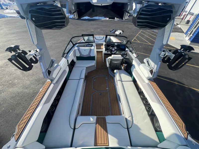 Slide: The Image of 2024 Nautique G25 boat interior with luxurious seating and advanced audio system. - 13