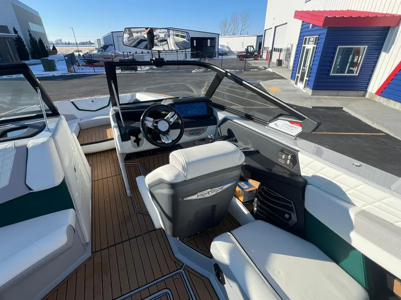 Slide: The Image of 2024 Nautique G25 boat interior with modern dashboard and luxurious seating. - 18