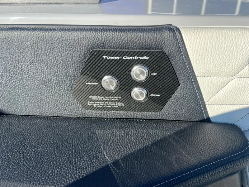 Slide: The Image of 2024 Nautique G25 tower controls on black leather panel. - 19
