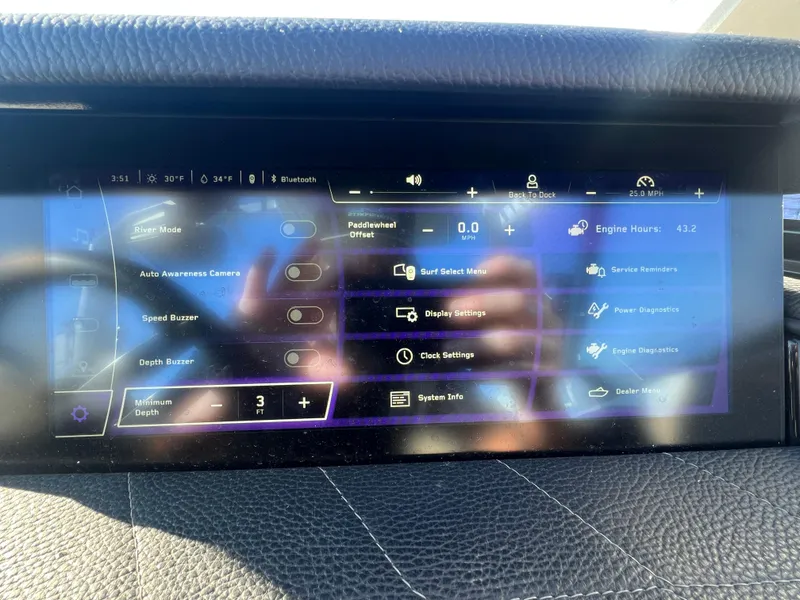 Slide: The Image of 2024 Nautique G25 touchscreen display showing various boat settings and diagnostics options. - 21