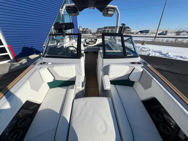 Slide: The Image of 2024 Nautique G25 boat interior with white seating and modern design. - 24