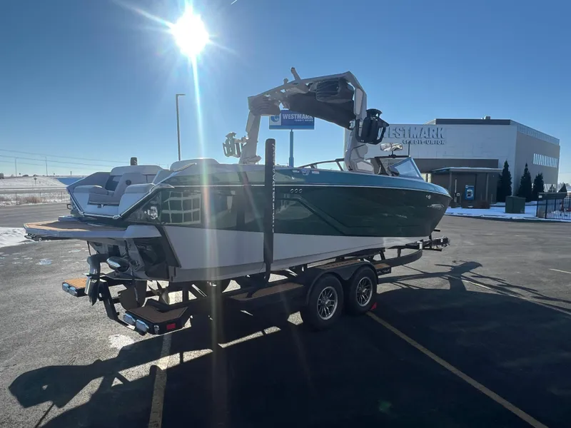 Slide: The Image of 2024 Nautique G25 boat on trailer in sunny parking lot. - 6