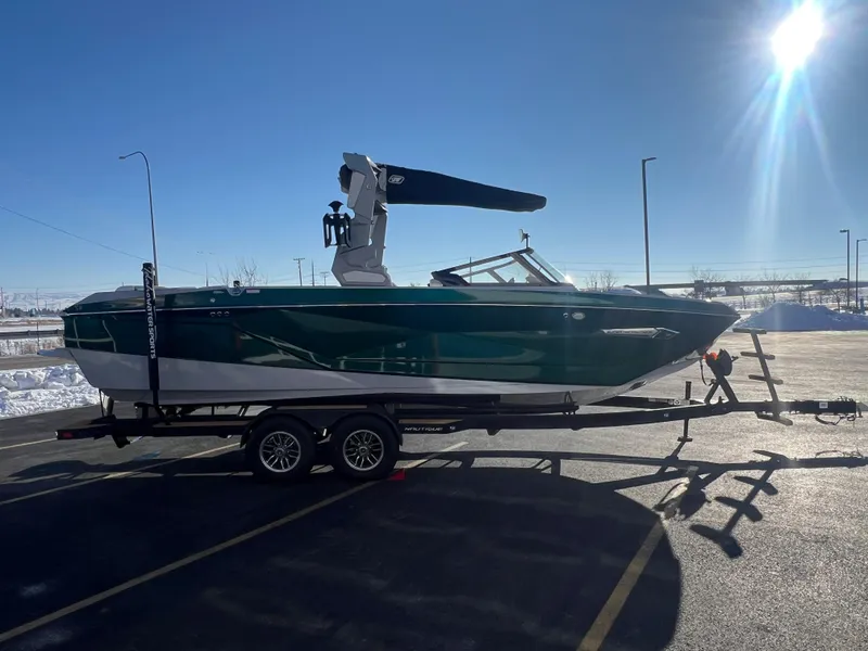 Slide: The Image of 2024 Nautique G25 boat on trailer in sunny parking lot. - 7