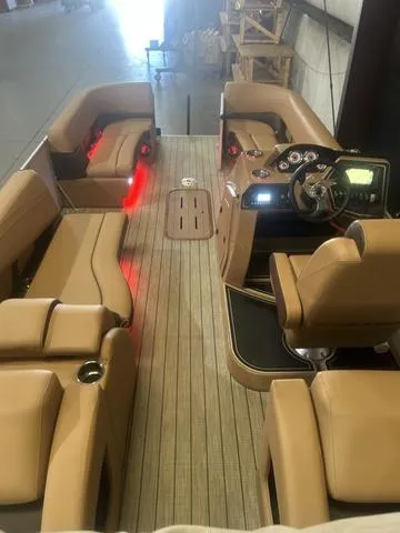 Slide: The Image of 2025 SunCatcher Fusion Series 324SS boat interior with tan seating and modern dashboard. - 12