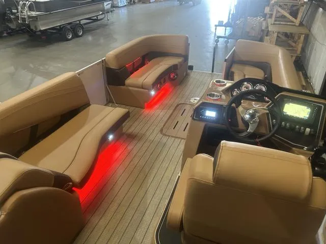 Slide: The Image of 2025 SunCatcher Fusion Series 324SS interior with Yamaha 250, featuring red LED lighting. - 14