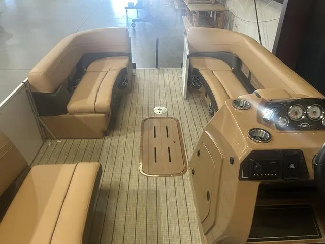 Slide: The Image of 2025 SunCatcher Fusion Series 324SS boat interior with tan seating and control panel. - 19