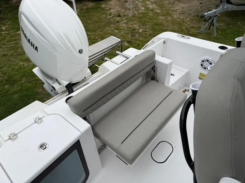 Slide: The Image of 2025 Sportsman Open 212 Center Console boat with Yamaha engine and foldable seating. - 12