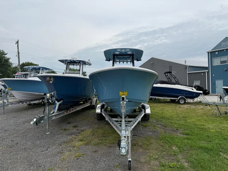 Slide: The Image of 2025 Sportsman Open 212 Center Console boat on trailer, displayed outdoors. - 2