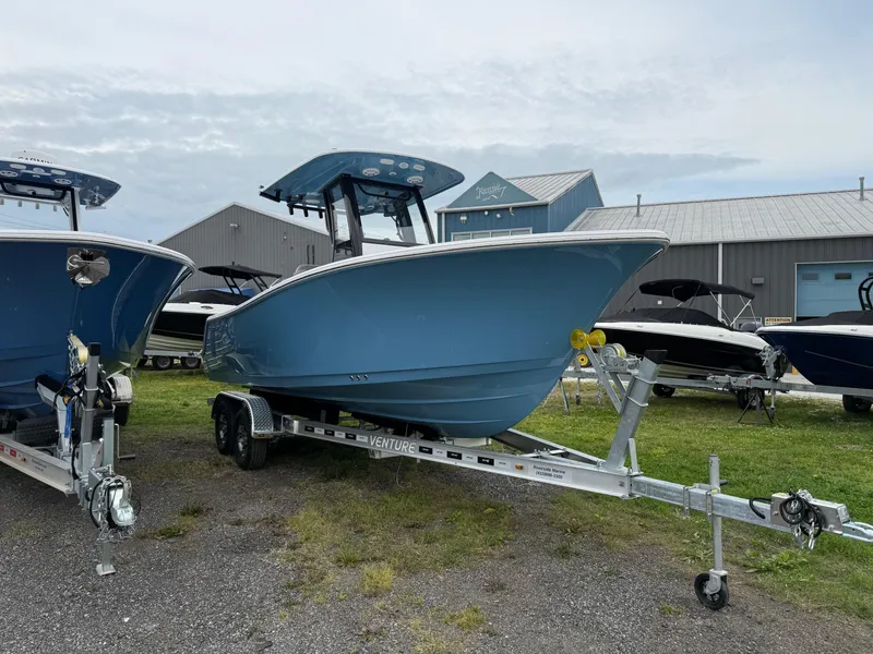 Slide: The Image of 2025 Sportsman Open 212 Center Console boat on trailer, displayed outdoors. - 3