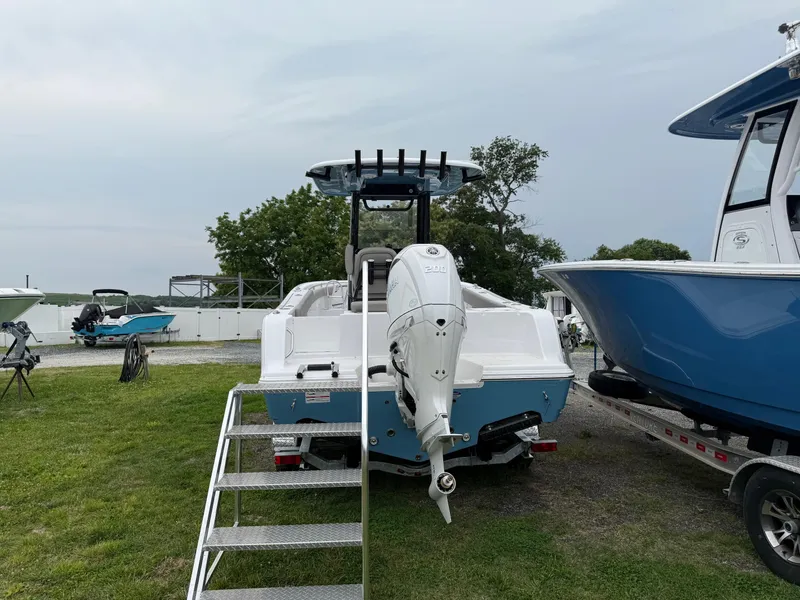 Slide: The Image of 2025 Sportsman Open 212 Center Console boat displayed outdoors with outboard motor. - 5
