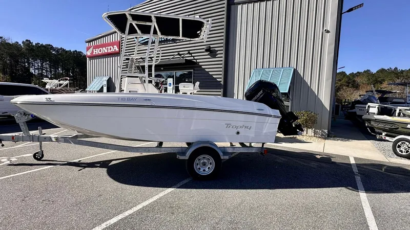 Slide: The Image of 2025 Bayliner T18 Limited Edition boat on trailer outside dealership. - 2