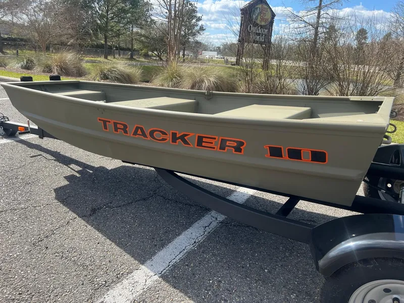 Slide: The Image of 2025 Tracker Grizzly 1036 Utility boat on trailer, parked outdoors. - 2
