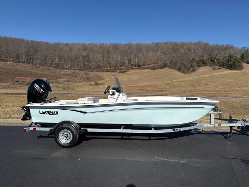 The Image of 2025 Mako Pro Skiff 17 CC boat on trailer, parked outdoors. - 0