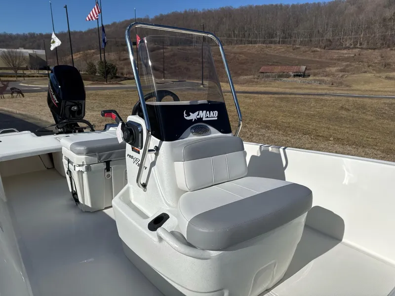 Slide: The Image of 2025 Mako Pro Skiff 17 CC boat with center console and seating, outdoors. - 4