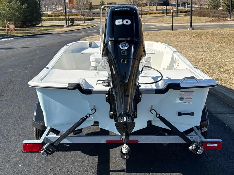 Slide: The Image of 2025 Mako Pro Skiff 17 CC with 60 HP Mercury engine on trailer. - 6