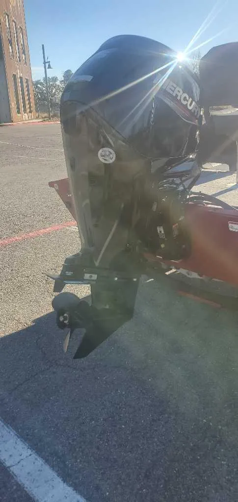 Slide: The Image of 2025 Tracker Pro Team 175 Crappie Edition boat with Mercury outboard motor in sunlight. - 2