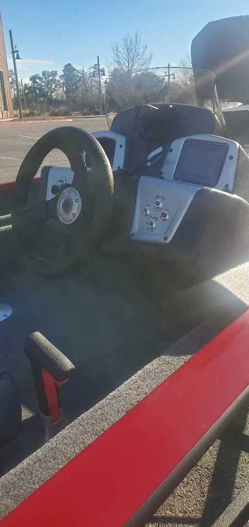 Slide: The Image of 2025 Tracker Pro Team 175 Crappie Edition boat interior with steering wheel and control panel. - 3