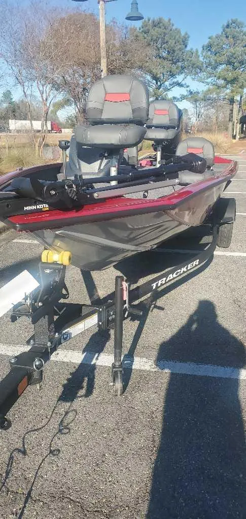Slide: The Image of 2025 Tracker Pro Team 175 Crappie Edition boat on trailer in parking lot. - 4