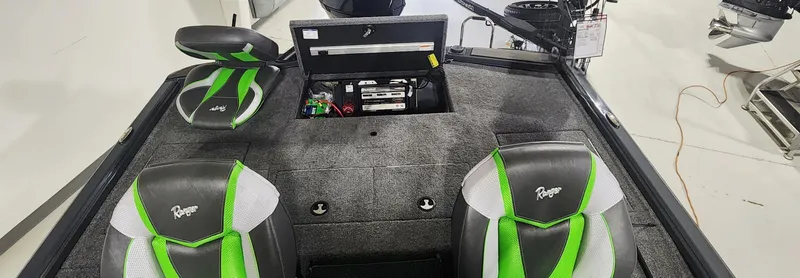 Slide: The Image of 2025 Ranger ALPHA 208 boat interior with green and black seats, storage compartments. - 8