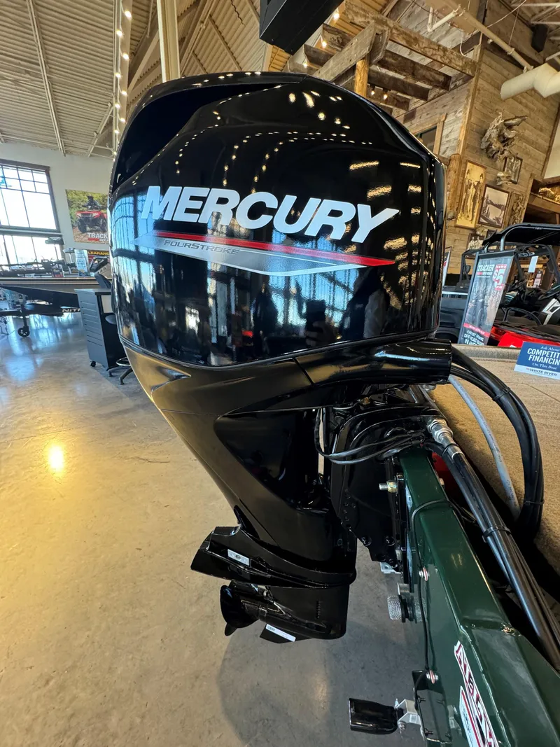Slide: The Image of 2025 Tracker Bass Tracker Classic Limited with Mercury outboard motor in showroom. - 4