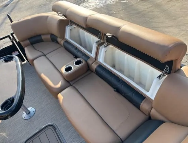 Slide: The Image of 2024 Regency 250 LE3 boat interior with tan seating and cup holders. - 10