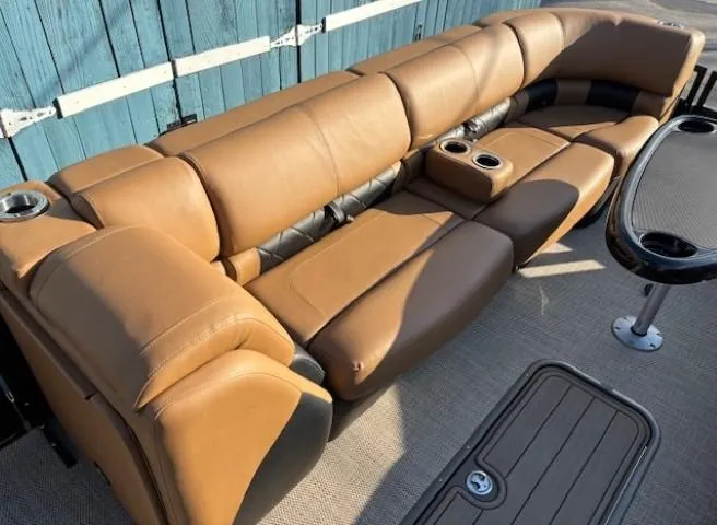 Slide: The Image of 2024 Regency 250 LE3 boat interior with brown leather seating and cup holders. - 12