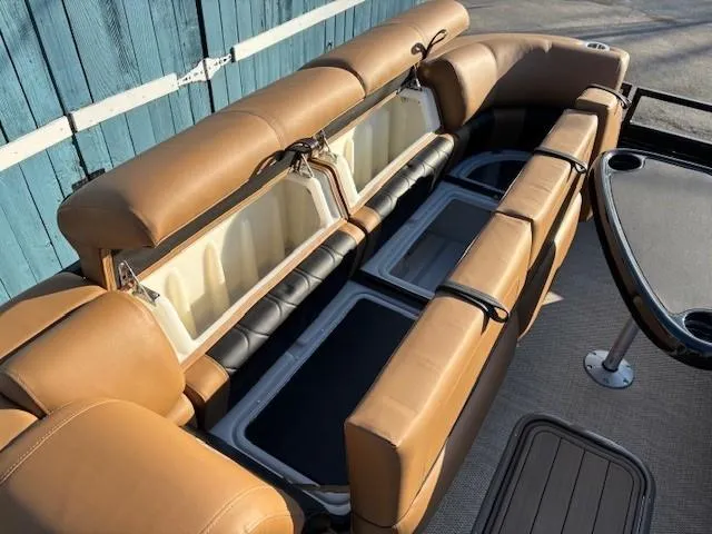 Slide: The Image of 2024 Regency 250 LE3 boat interior with tan seating and storage compartments. - 13