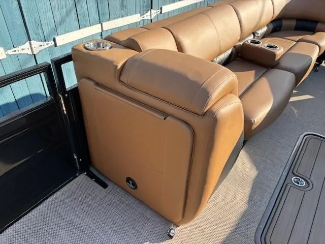 Slide: The Image of 2024 Regency 250 LE3 boat interior with brown leather seating and cup holders. - 14