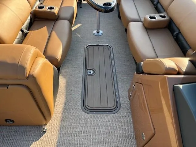 Slide: The Image of 2024 Regency 250 LE3 boat interior with tan seating and cup holders. - 16