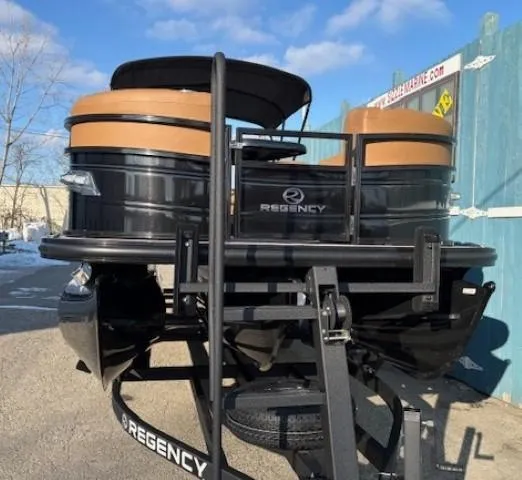 Slide: The Image of 2024 Regency 250 LE3 pontoon boat on trailer, black and tan design, outdoor setting. - 2