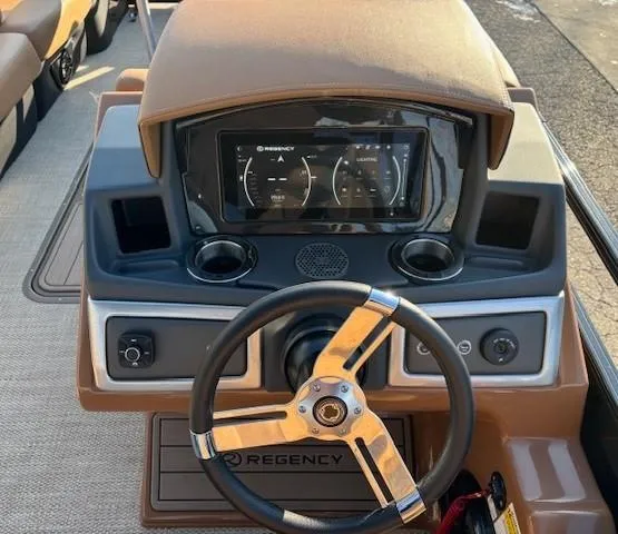 Slide: The Image of 2024 Regency 250 LE3 boat dashboard with steering wheel and digital display. - 20