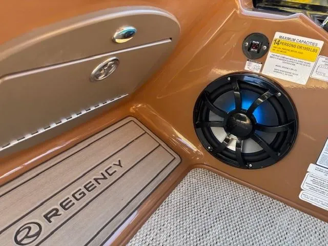 Slide: The Image of 2024 Regency 250 LE3 boat interior with speaker and capacity label. - 22
