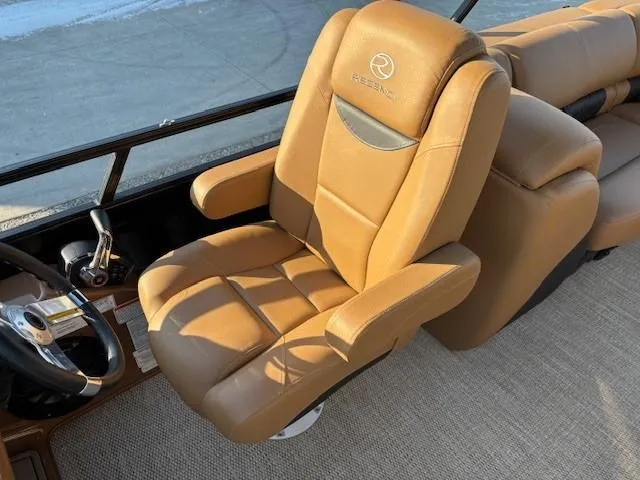 Slide: The Image of Luxurious tan captain's chair in 2024 Regency 250 LE3 boat interior. - 23