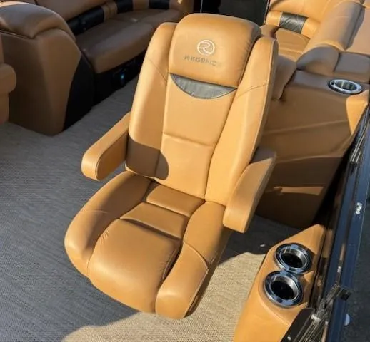 Slide: The Image of 2024 Regency 250 LE3 luxury boat seating with tan leather and cup holders. - 24