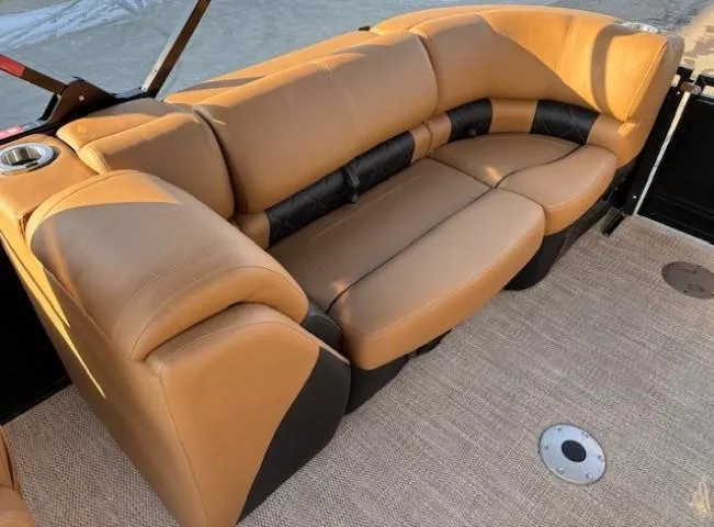 Slide: The Image of 2024 Regency 250 LE3 boat interior with tan leather seating and carpeted floor. - 26
